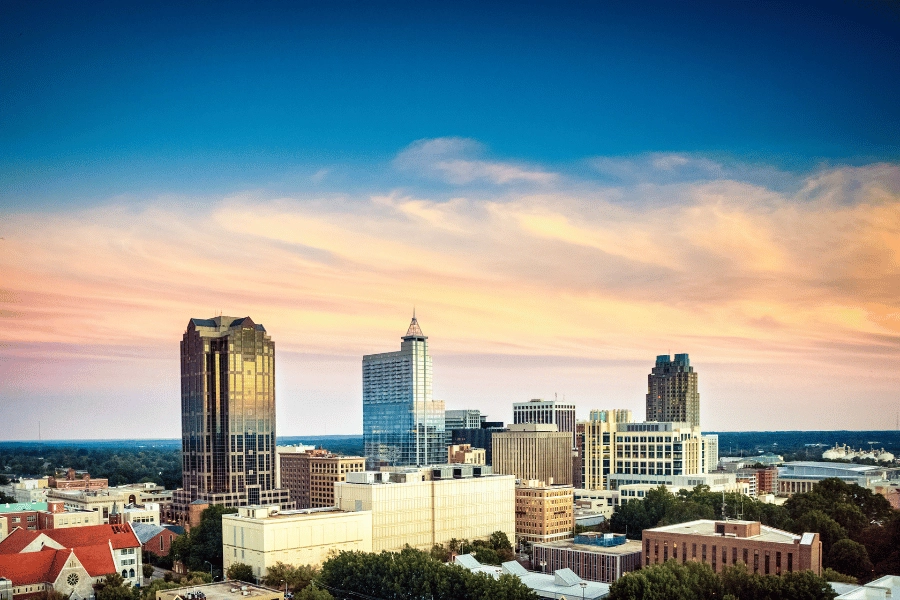 Downtown Raleigh skyline with tall buildings and clouds in the sky